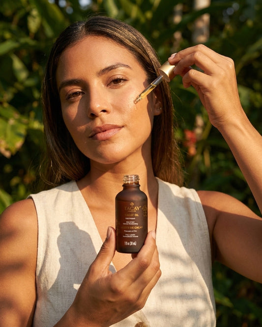 Woman applying cacay oil in golden hour light, suitable for every skin type